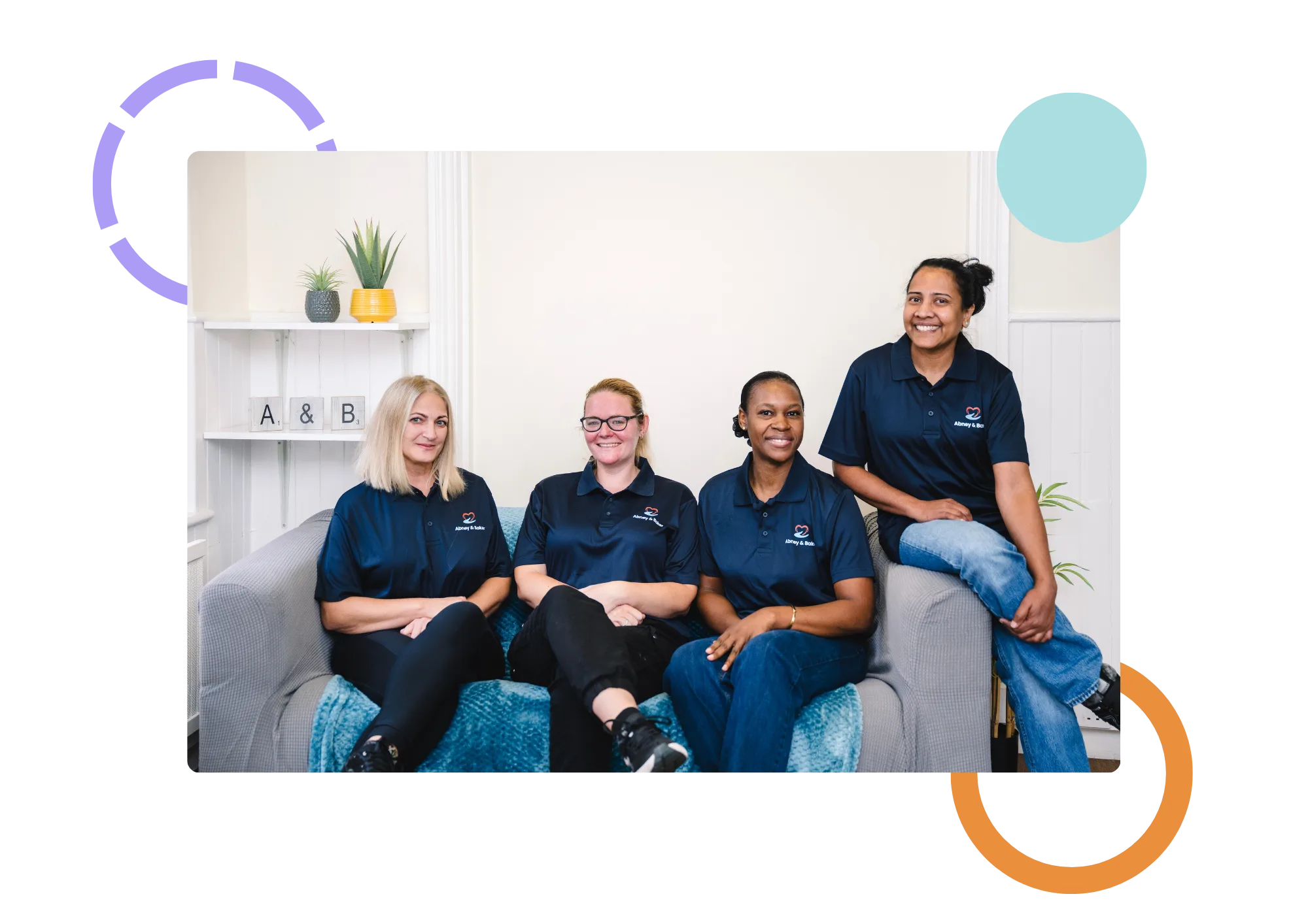 The Abney & Baker care team together on a sofa