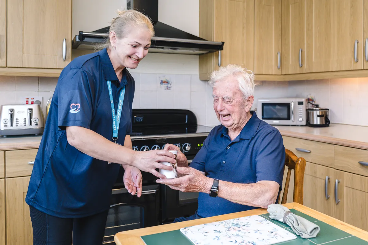A carer sharing a warm moment with a client