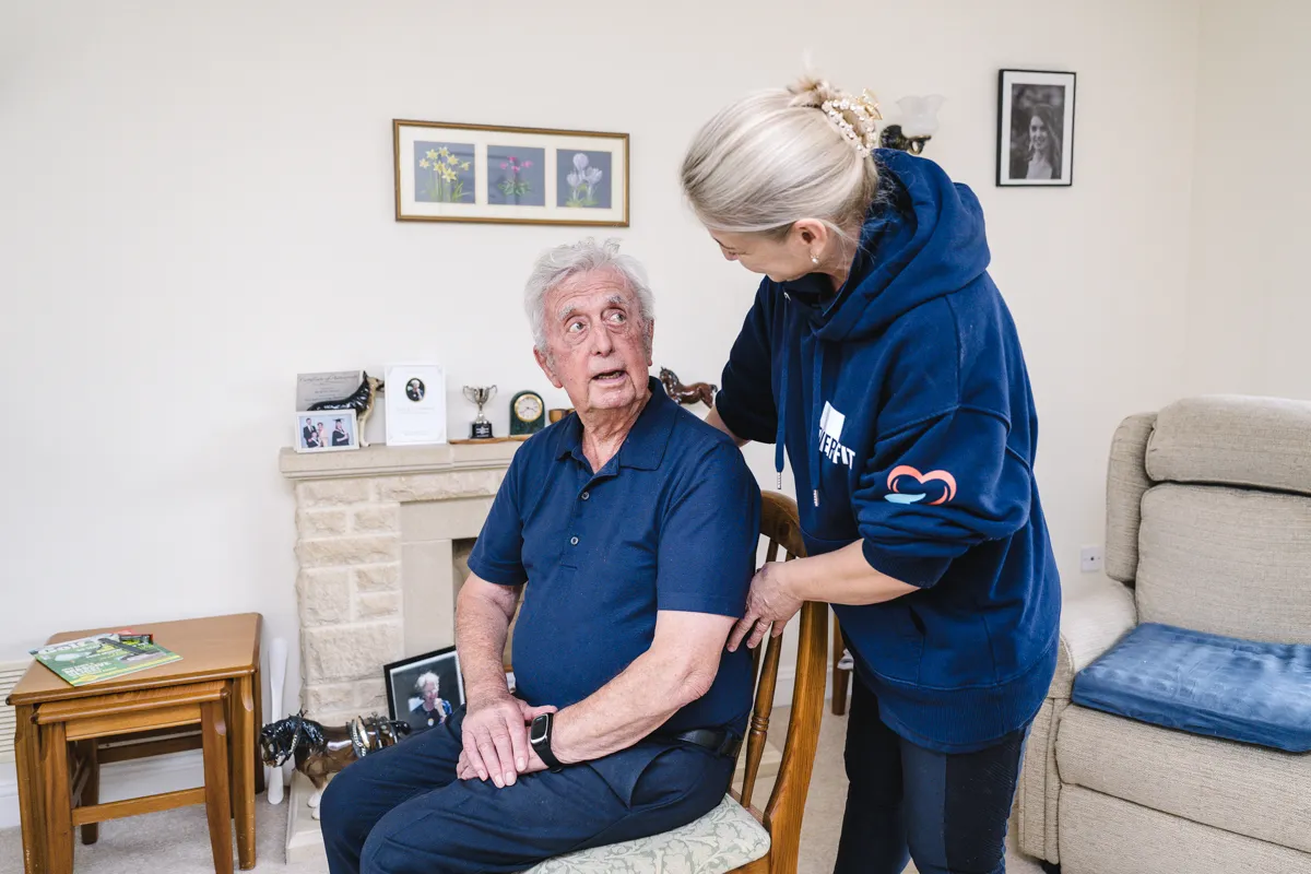 An Abney & Baker community support manager helping a client at home